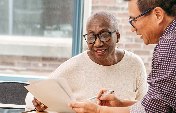 Older mother and son reviewing papers together.