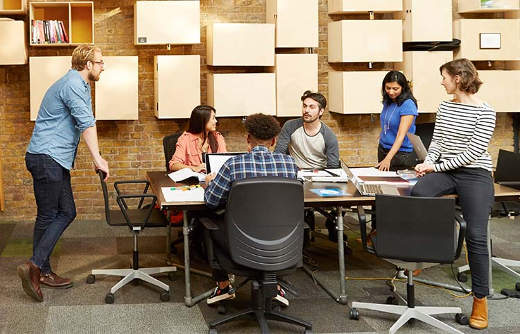 Five people gathered around a table